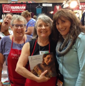 Left to right: Some of the Yarn Barn of Kansas team: Mary Margaret (photo-bomb!), Dianne, Susan - with Anne