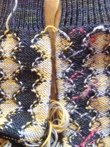 Close up of the WS.  Knitting on the right has been blocked, and had Accent lines duplicate stitched.