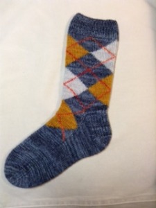 Kathi Doak was in the Argyle Socks class at Stitches East a mere two weeks ago, and has already knit her first full-sized sock!  She kindly sent me a photo and gave permission to share it with you.  I love the colors, which show off her exquisite knitting to perfection.  Great job, Kathi!  Now, just knit the second one :)