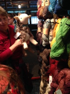 Marcia Weinert and her new sheep, "MacDugal", trying to make their way through a crowded booth.