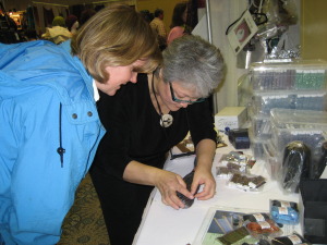 Elaine picking out the right beads for a project, at Madrona,