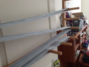 Winding the strands onto a warping board.  At the bottom, see where the yarn is "crossing".  This keeps the strands separated.