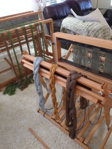 My loom is in front, and Tracy's is behind it. She is farther along in the warping process - her reed has already been sleyed.  You can see the strings going through the reed.