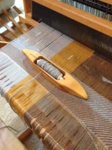 Beginning to weave the pillows. There are a few rows of waste yarn to set up, and now I am starting to weave a twill pattern.  This is my first attempt at anything other than plain weave.  So far, so good!