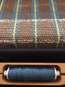 Playing with treadle patterns with a standard 1,2,3,4 threading.  Warp is Cotlin (brown), linen (yellow), and an unknown fiber (blue).  Weft is all Cotlin.  I started with white until I was bored, and am now working with Blue. 