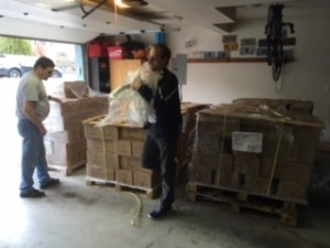 Sam and Randy are helping to unload and stack the boxes