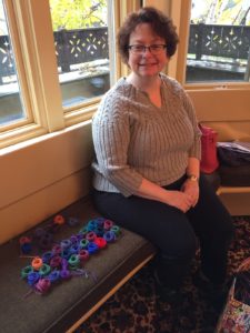 Elizabeth wound her yarn into small circles to arrange them for knitting. She will knit with the yarn as strands instead of butterflies, as they are short enough to pull through tangles easily.